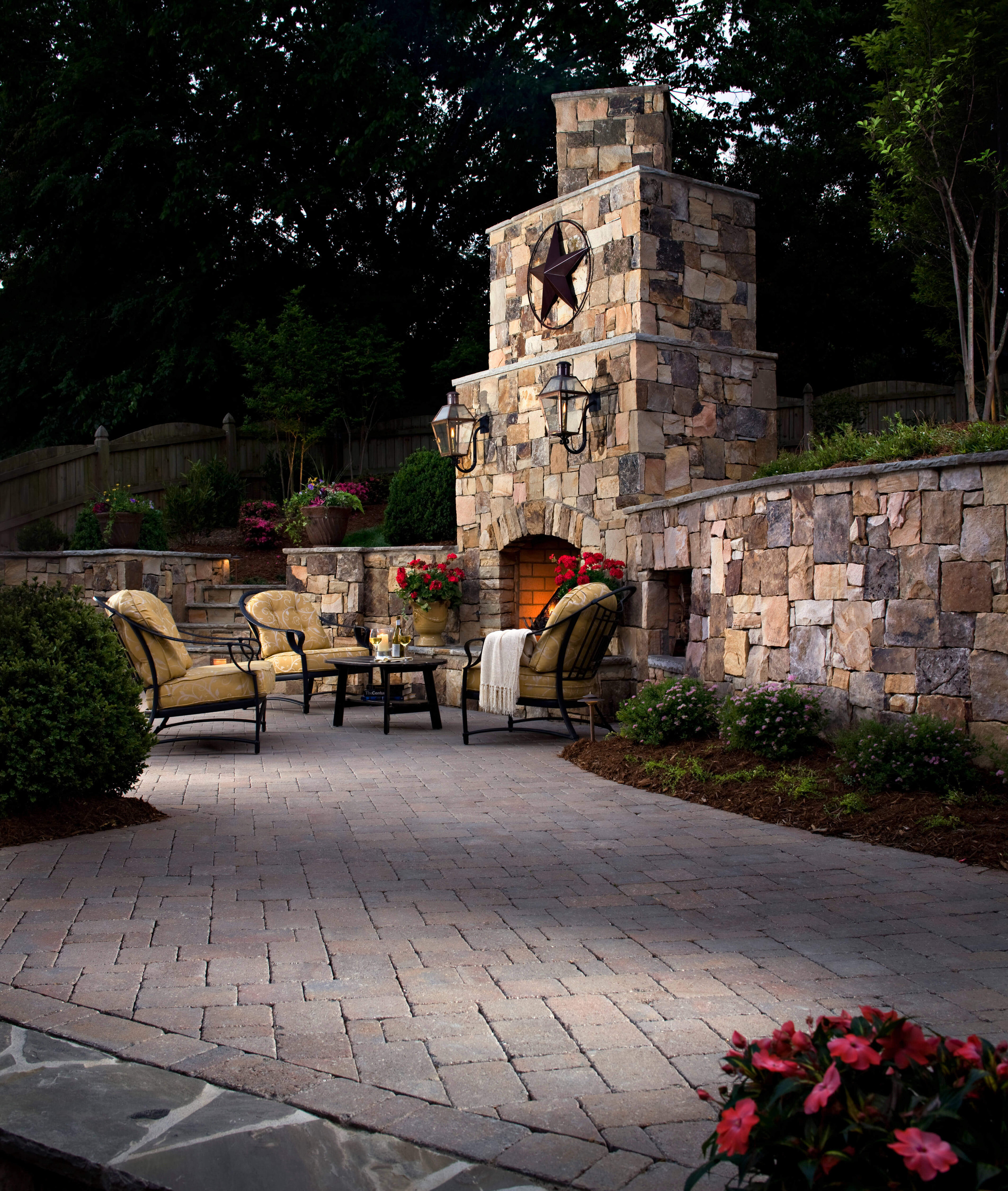 custom stone fireplace and paver patio backyard design idea