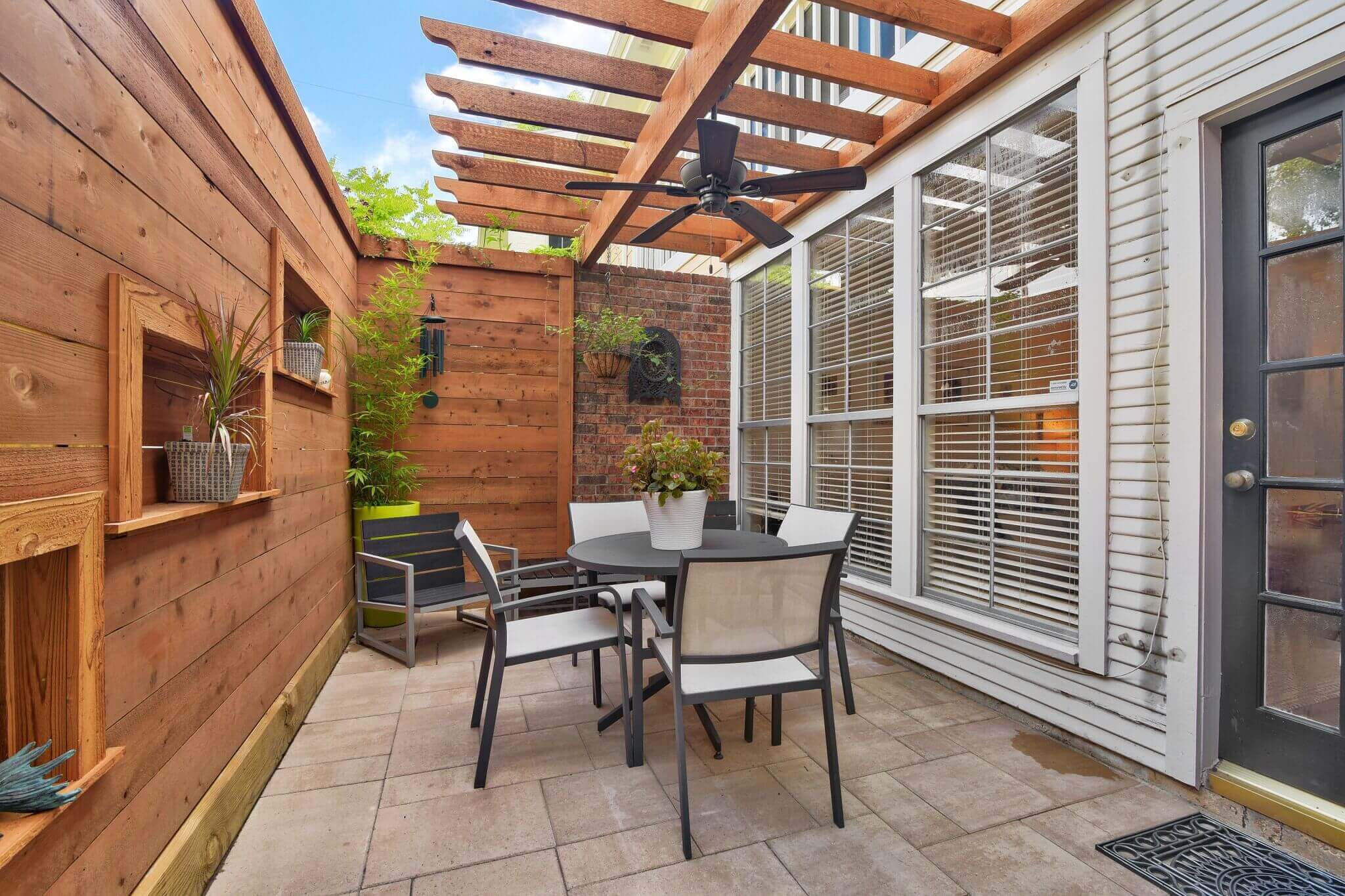 Small custom patio privacy wall and wooden pergola design