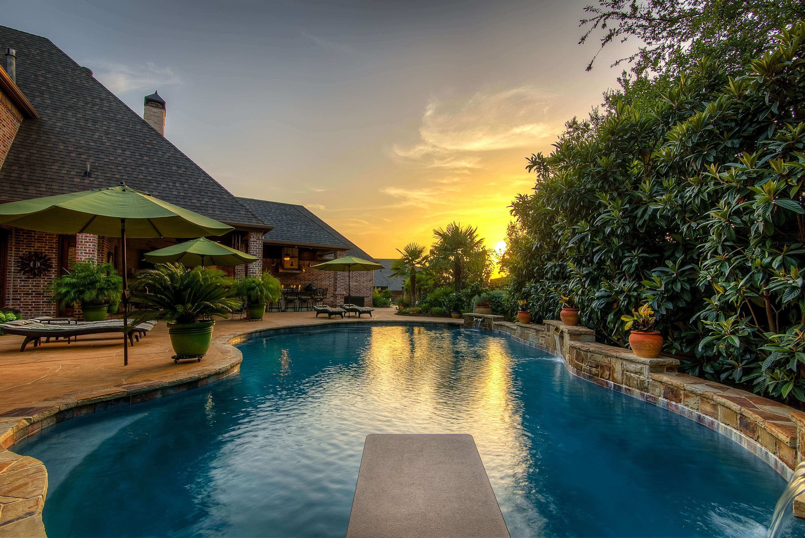 Backyard pool design idea diving board Texas sunset