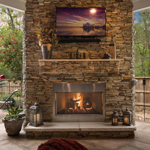 Outdoor stone fireplace design with tv mount