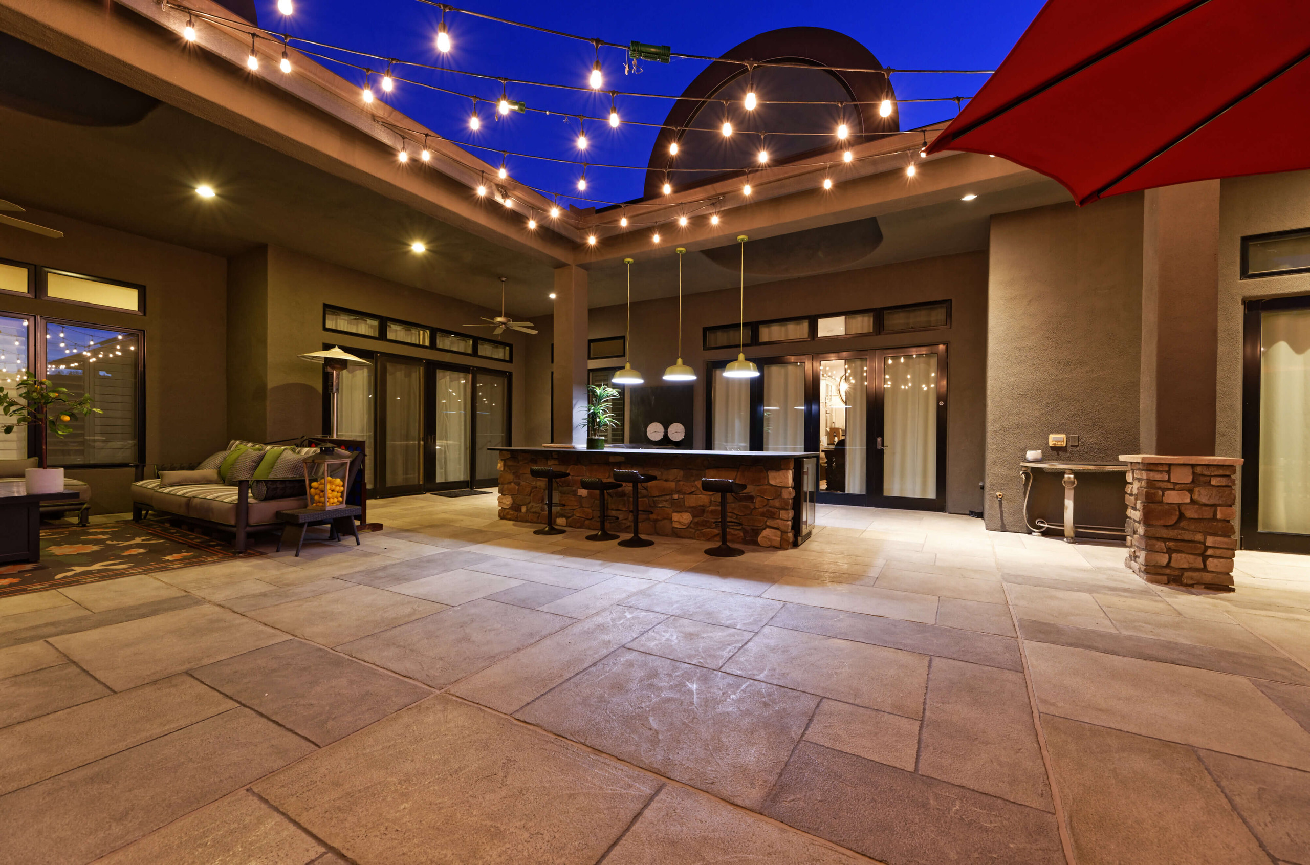 Gorgeous outdoor living space with string lights and spacious seating areas