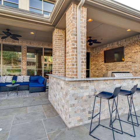 Stone detailing on an outdoor countertop with bar stools