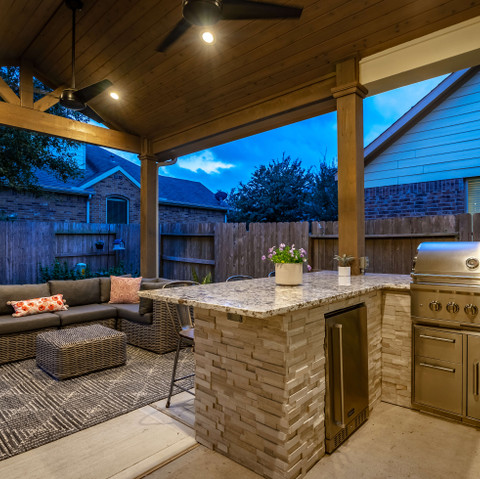 Covered patio with granite and stone detailed kitchen and comfortable seating area