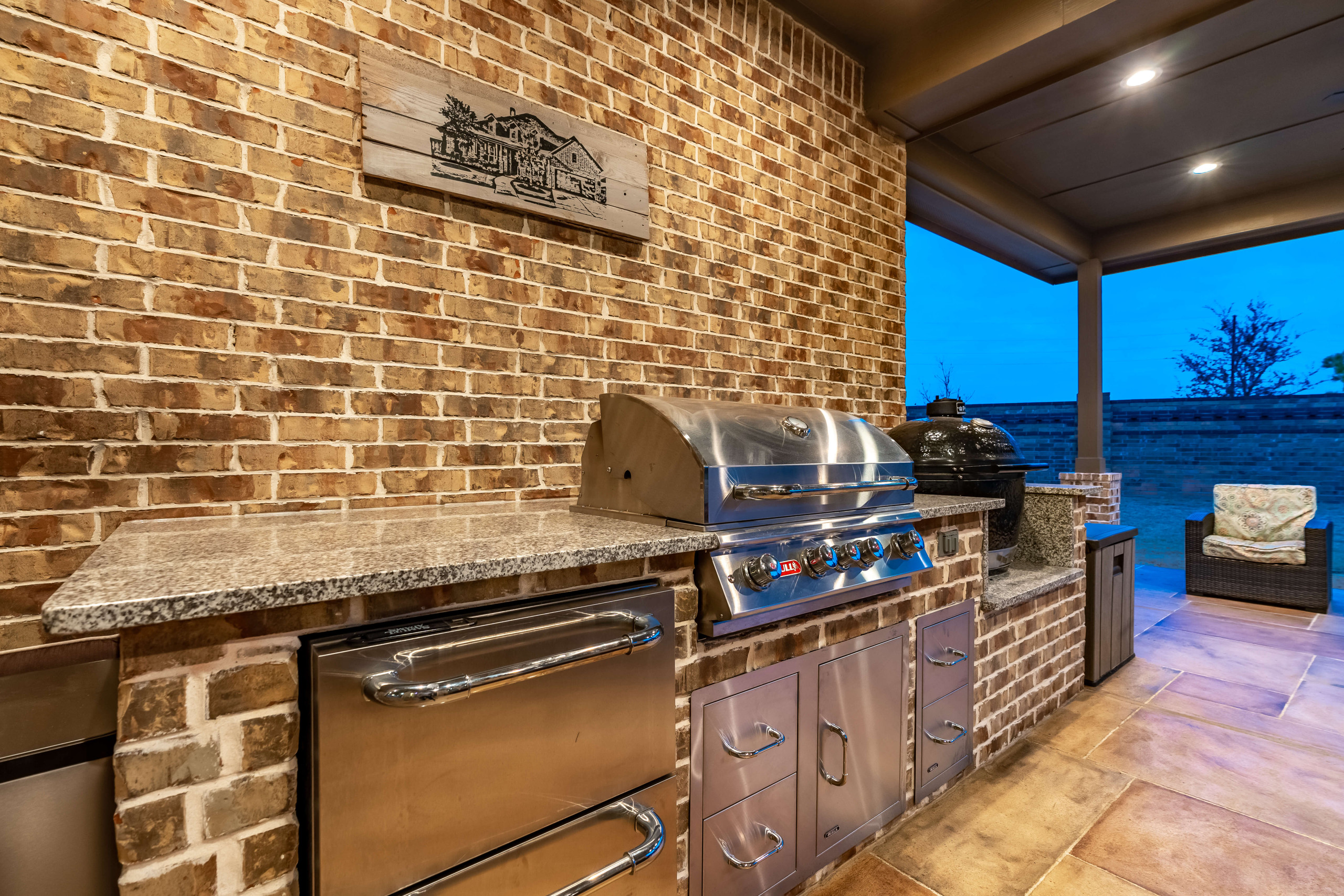 Outdoor grilling and kitchen area with shaded patio cover