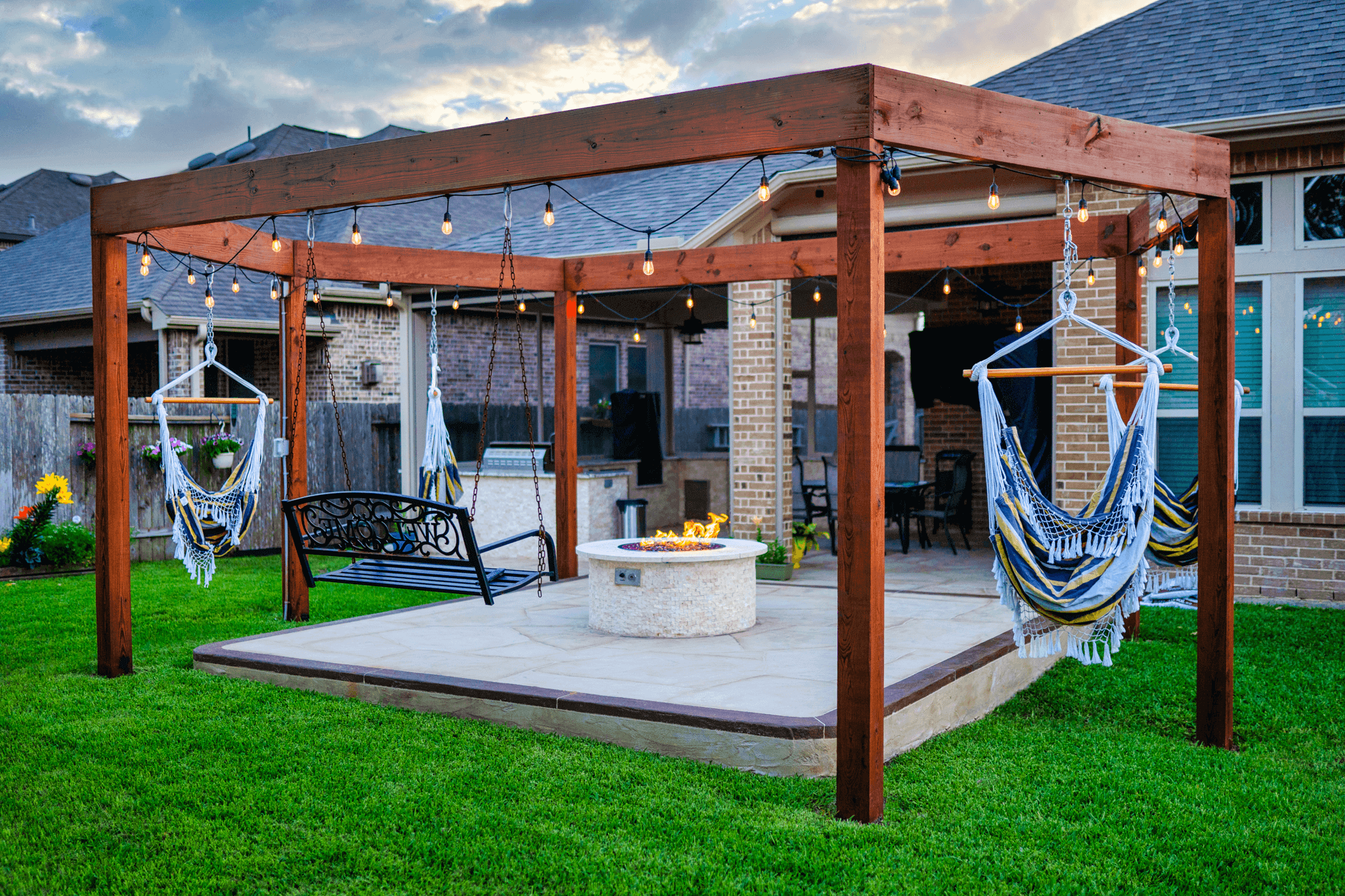 Custom built swing structure and stone detailed fire pit