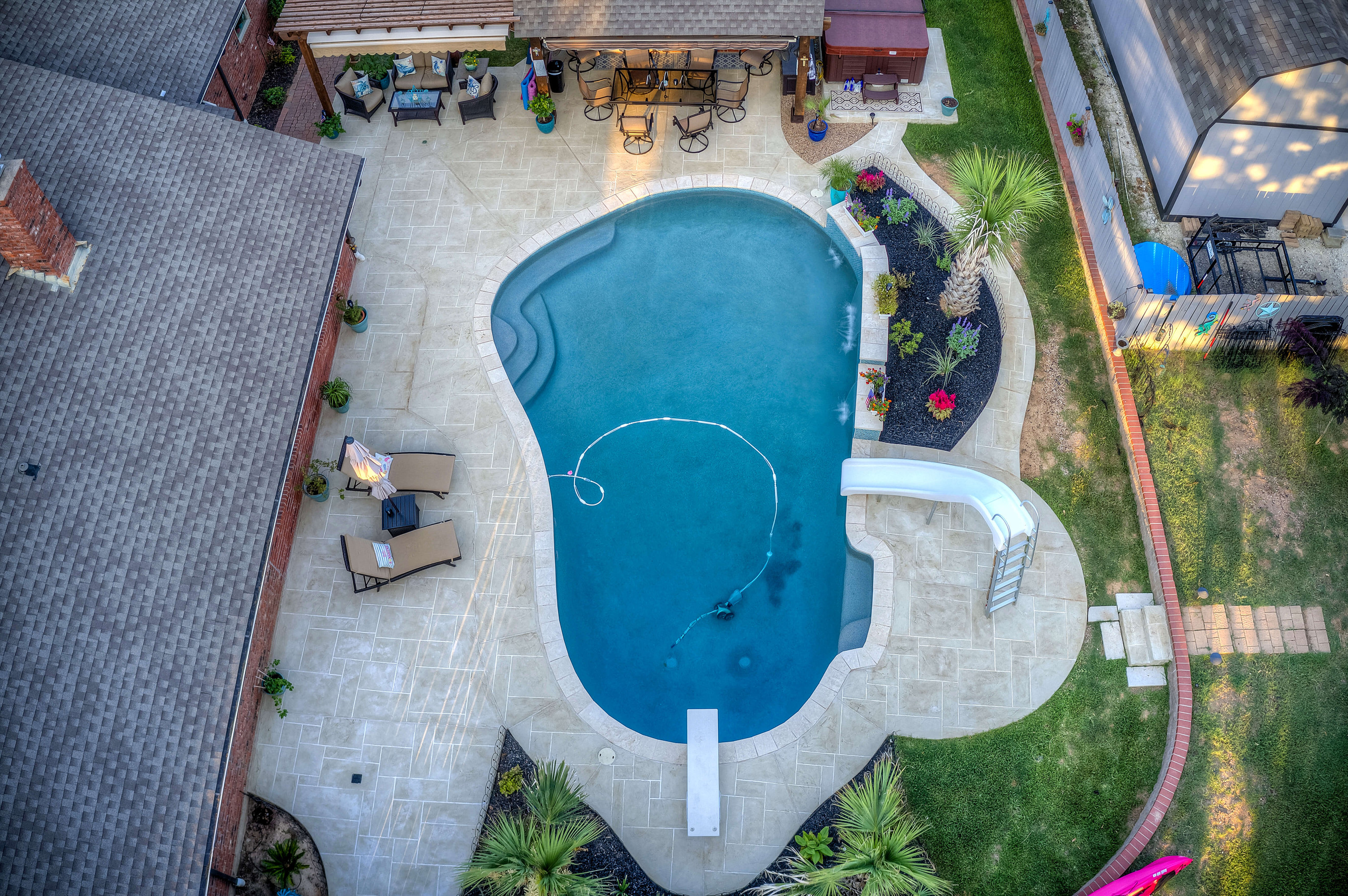 Carvestone pool deck and custom freeform backyard pool