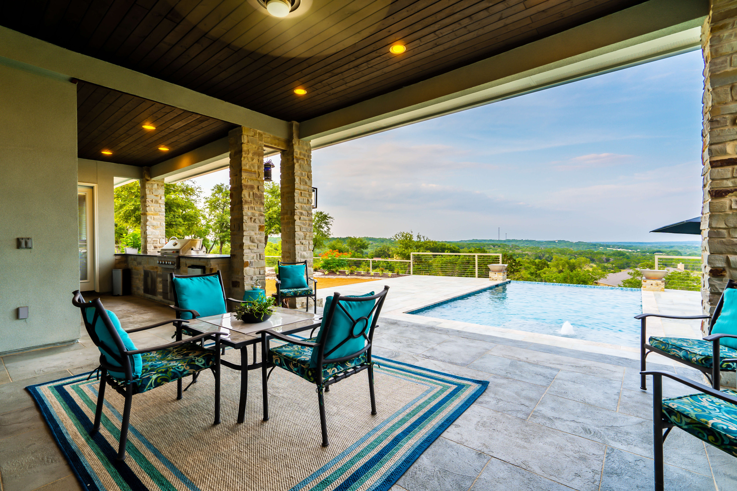 Outdoor living room with kitchen and pool view