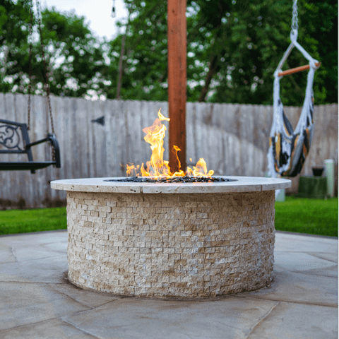 Stone round firepit design on backyard Texas patio