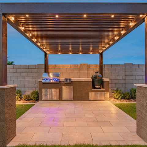 Aluminum pergola with outdoor grill station and a paver patio design idea