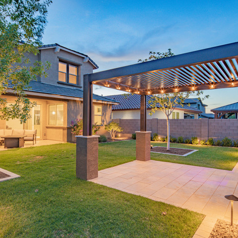 Backyard paver patio and aluminum pergola in Arizona design with outdoor lights