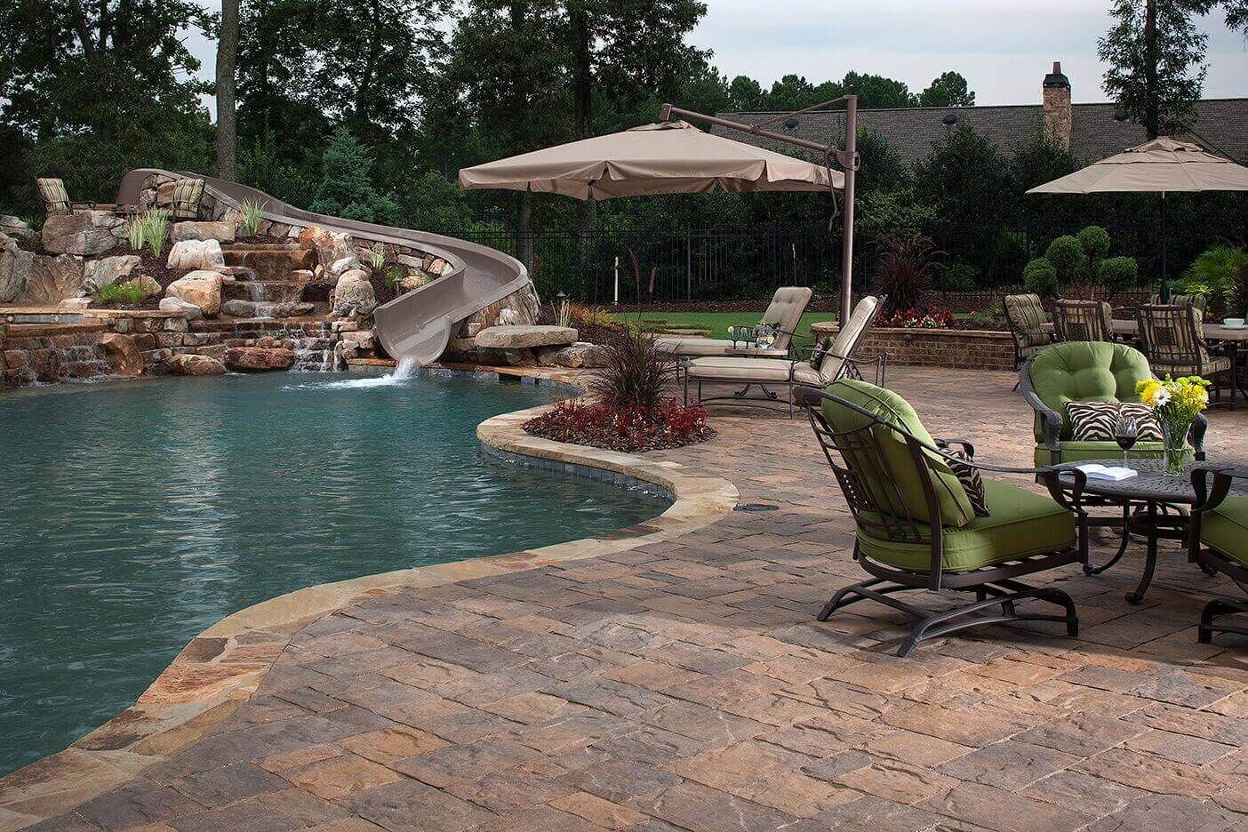 New pool build with slide and paver patio pool deck design idea The Woodlands Texas