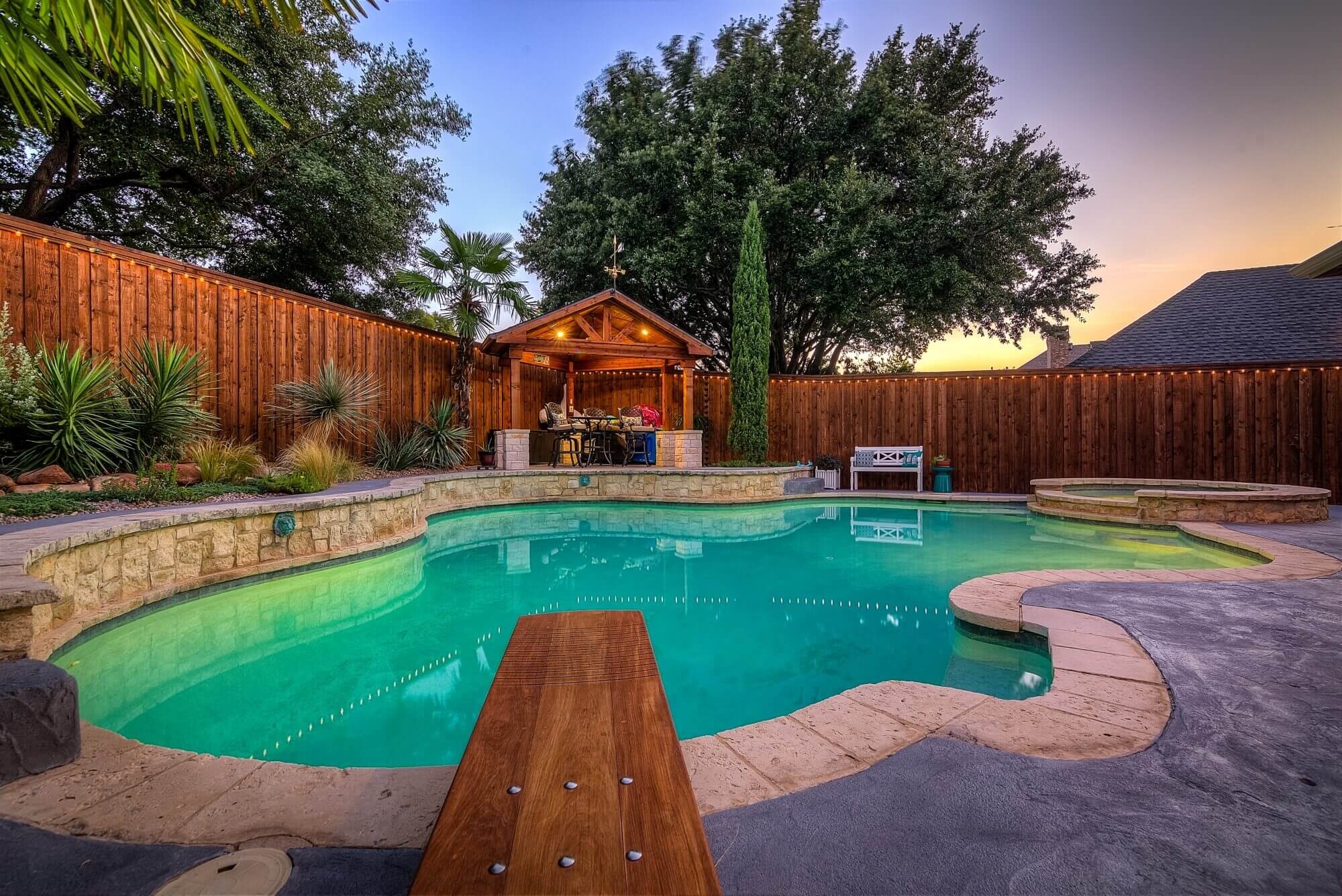 backyard outdoor pool paradise with diving board design idea