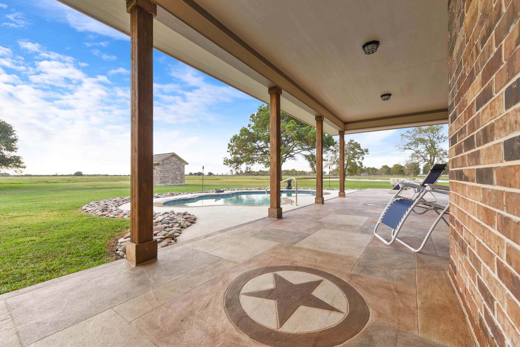 Carvestone overlay patio with custom emblem Texas star design idea