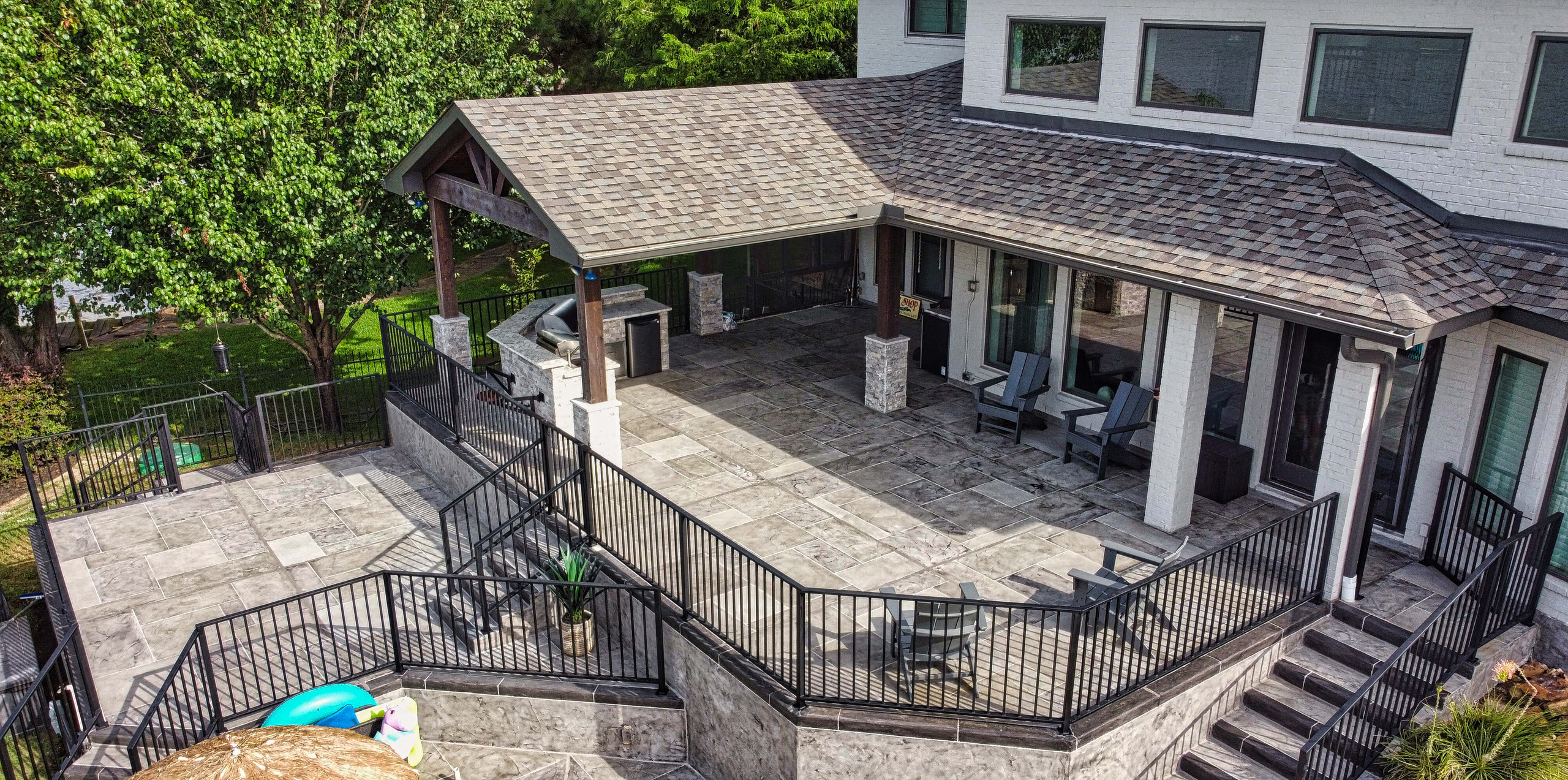 Modern patio design with custom carvestone concrete overlay in Houston Texas