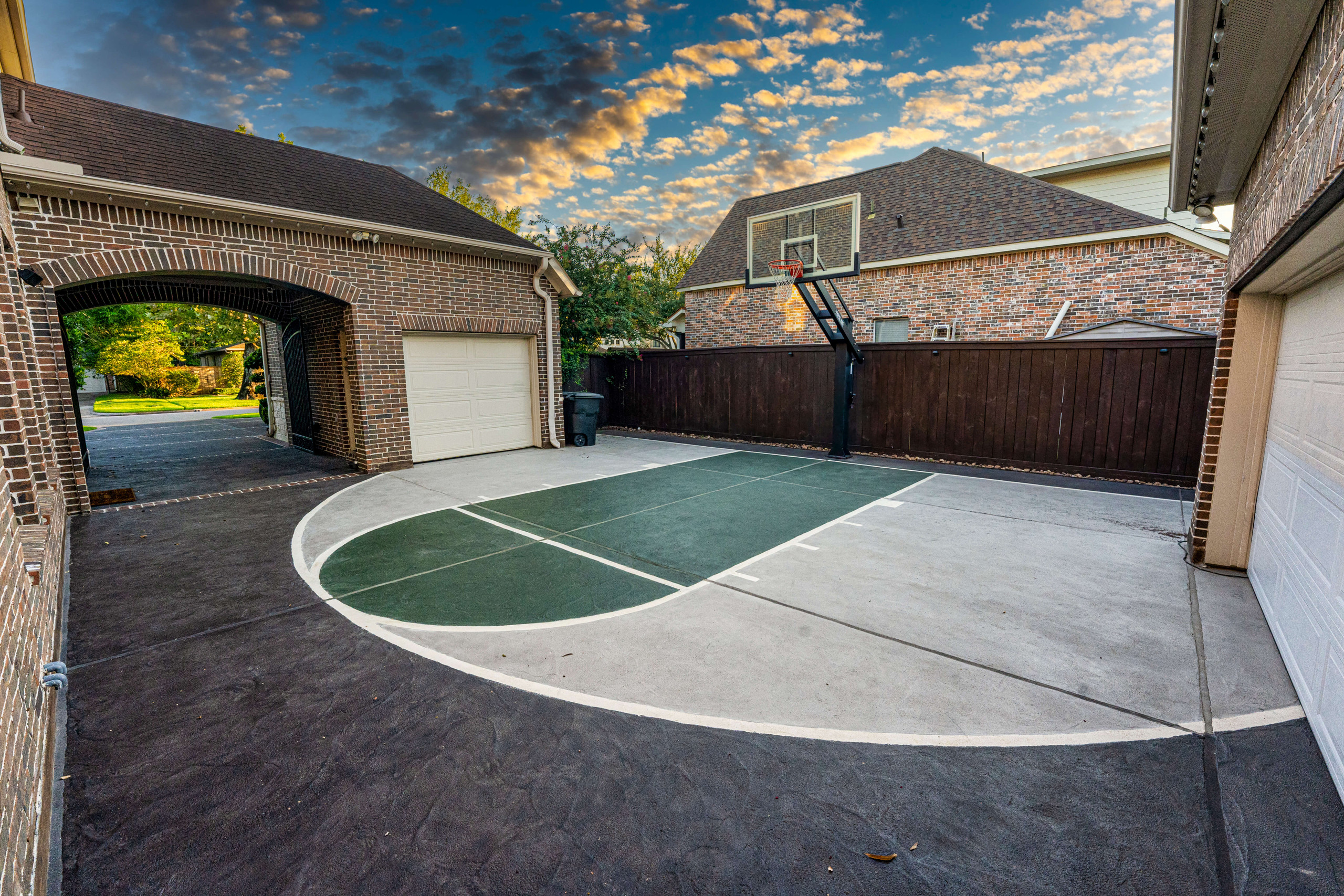 Custom carvestone concrete overlay hand-carved basketball court driveway in Houston Texas