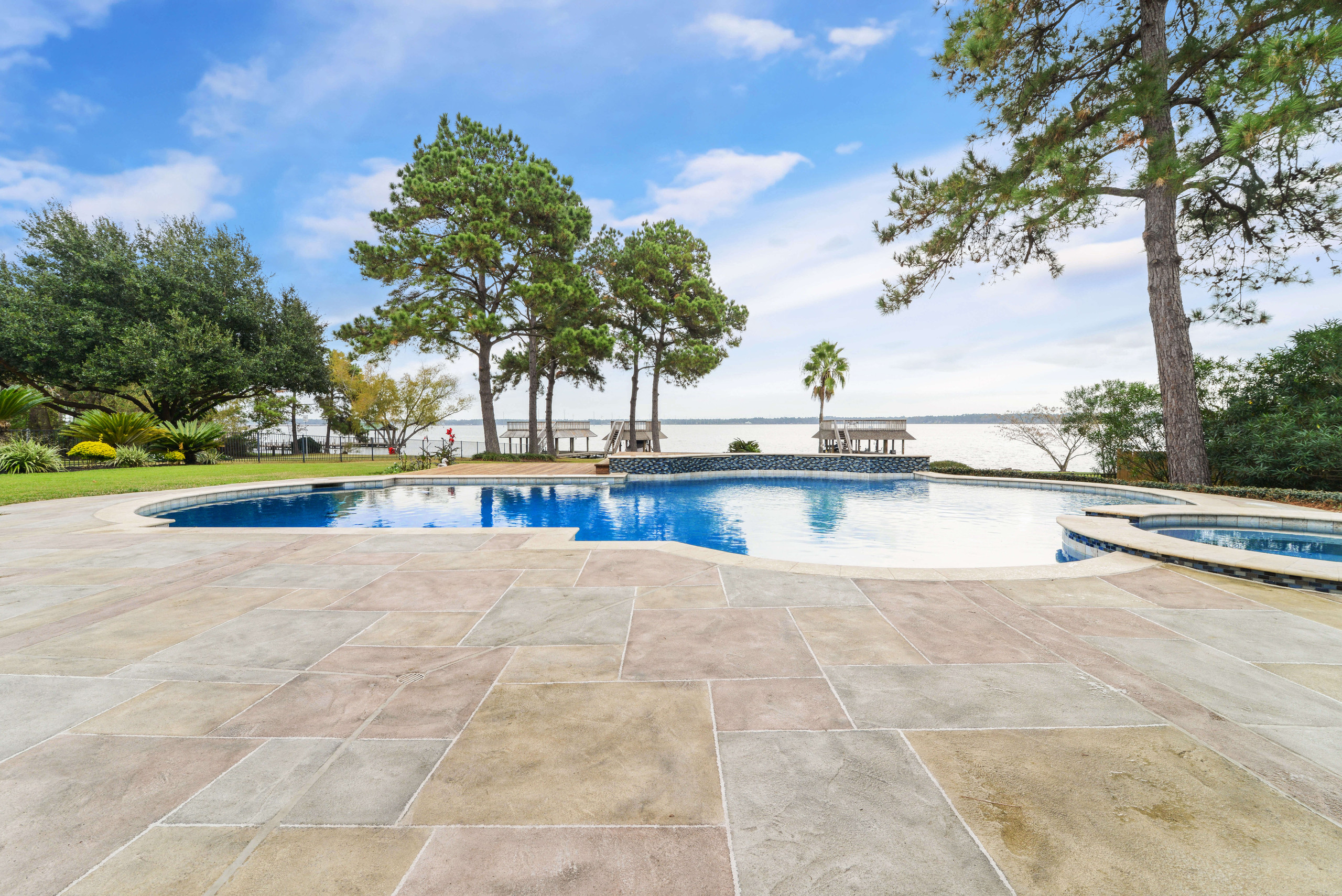 Tan carvestone concrete pool decking design patio idea backyard views Texas
