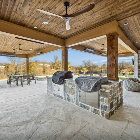 stone outdoor kitchen grilling and carvestone overlay patio