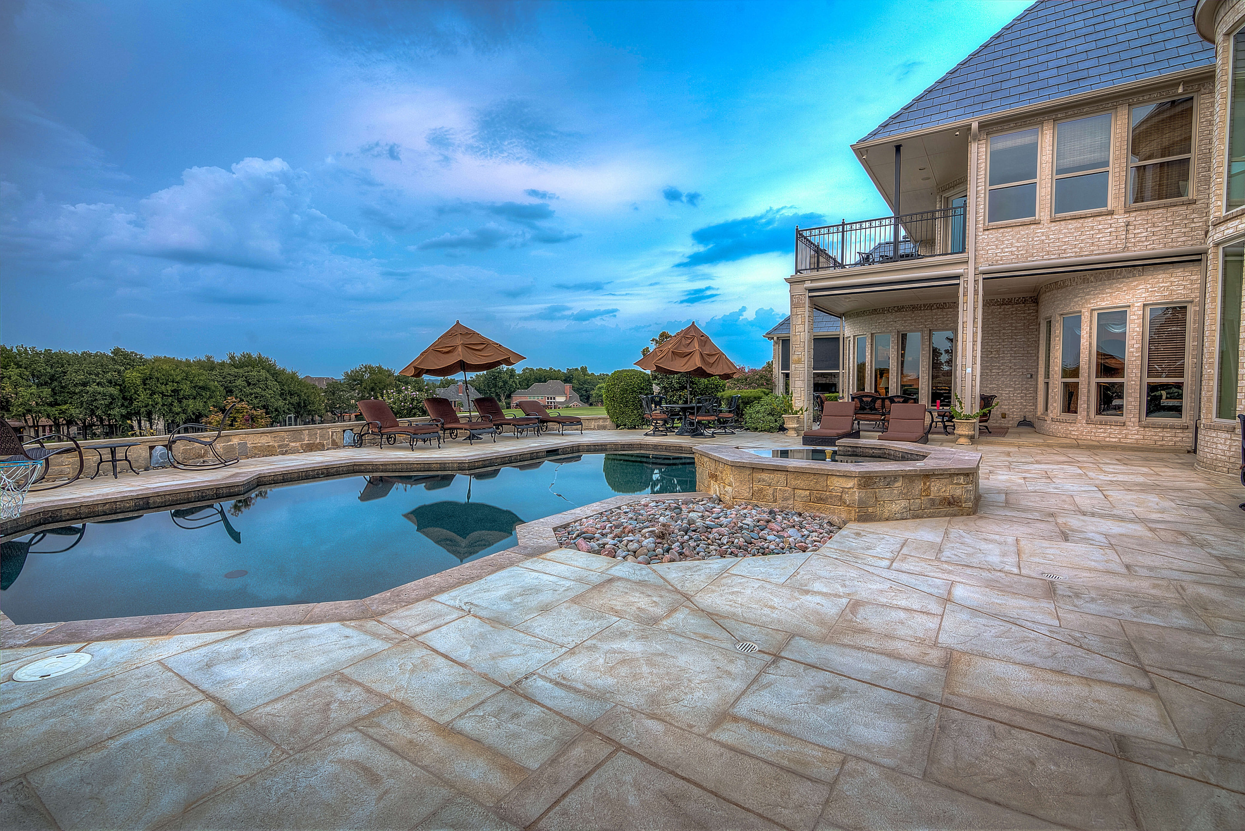 modern overlay pool deck solution Carvestone design backyard in Fort Worth Texas