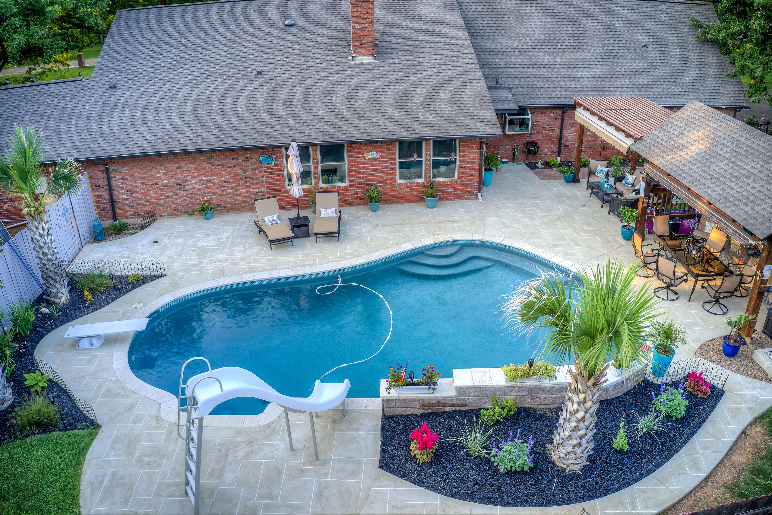 Tan pool deck design idea custom Carvestone overlay hand-troweled