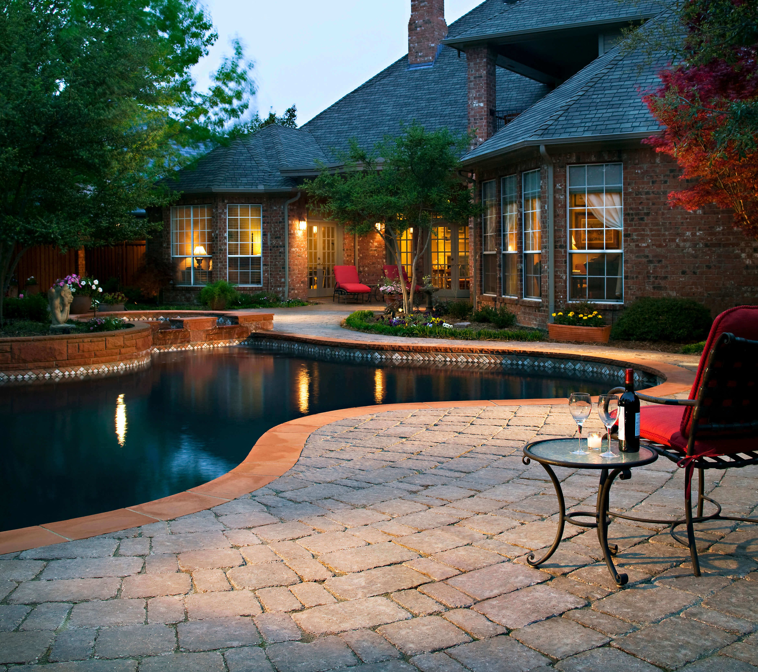 paver pool decking with stone border design idea