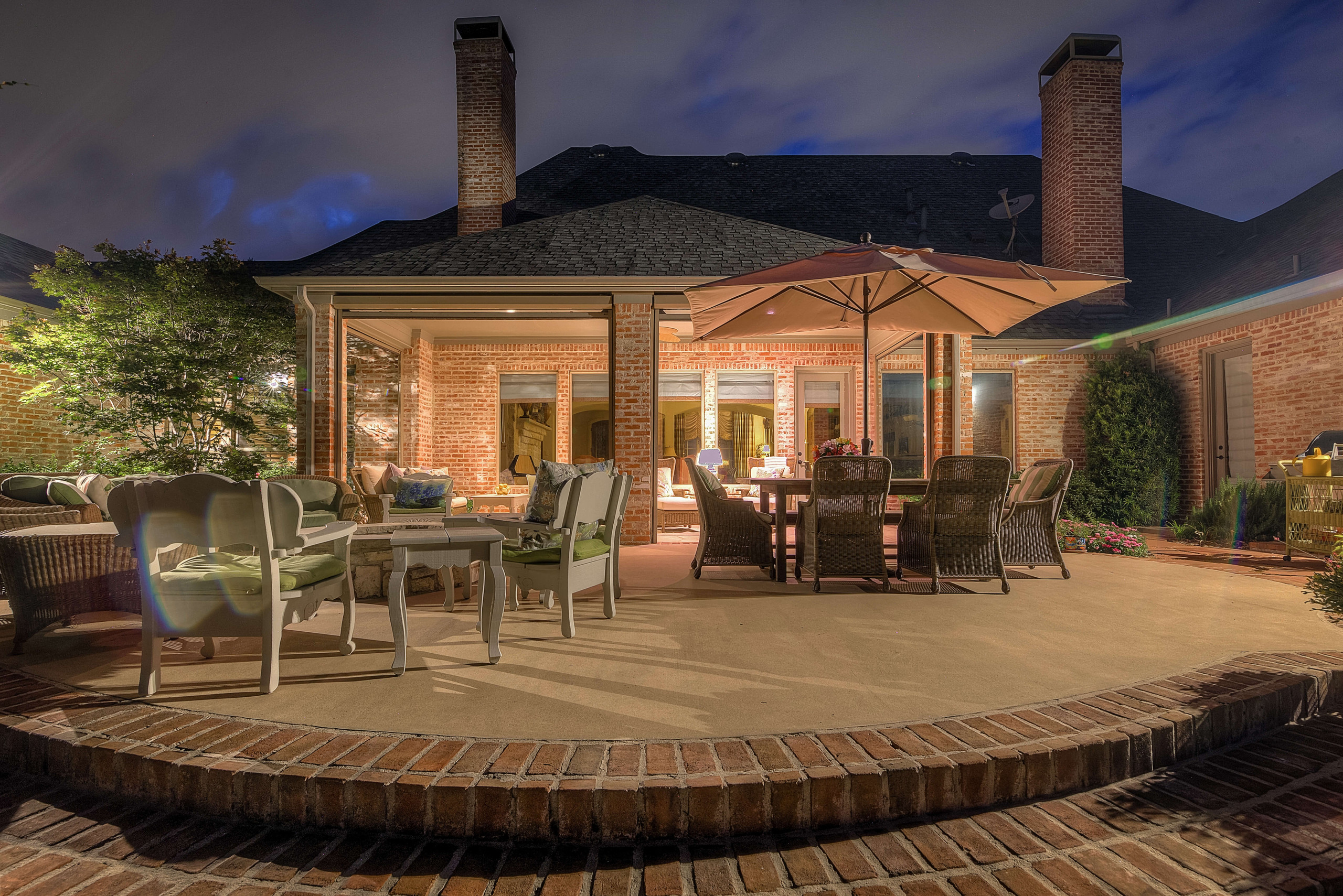 backyard concrete patio with brick design and border