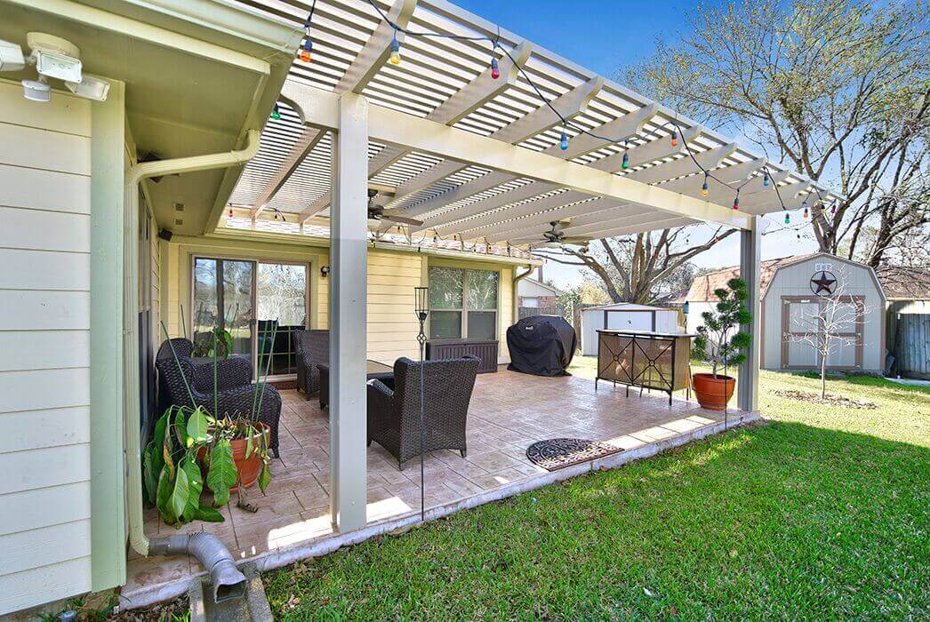 White pergola and stamped concrete patio extension