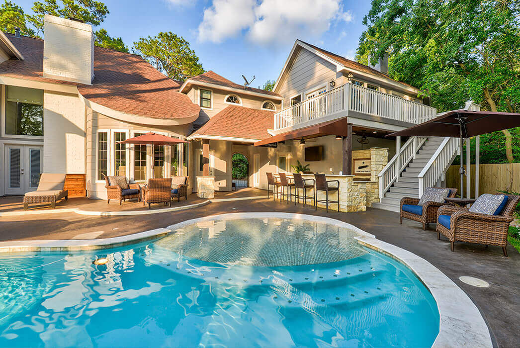 In-ground backyard pool and carvestone pool decking