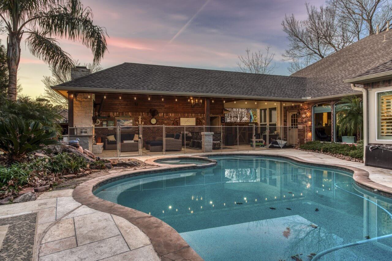 Custom pool build and covered patio living room area