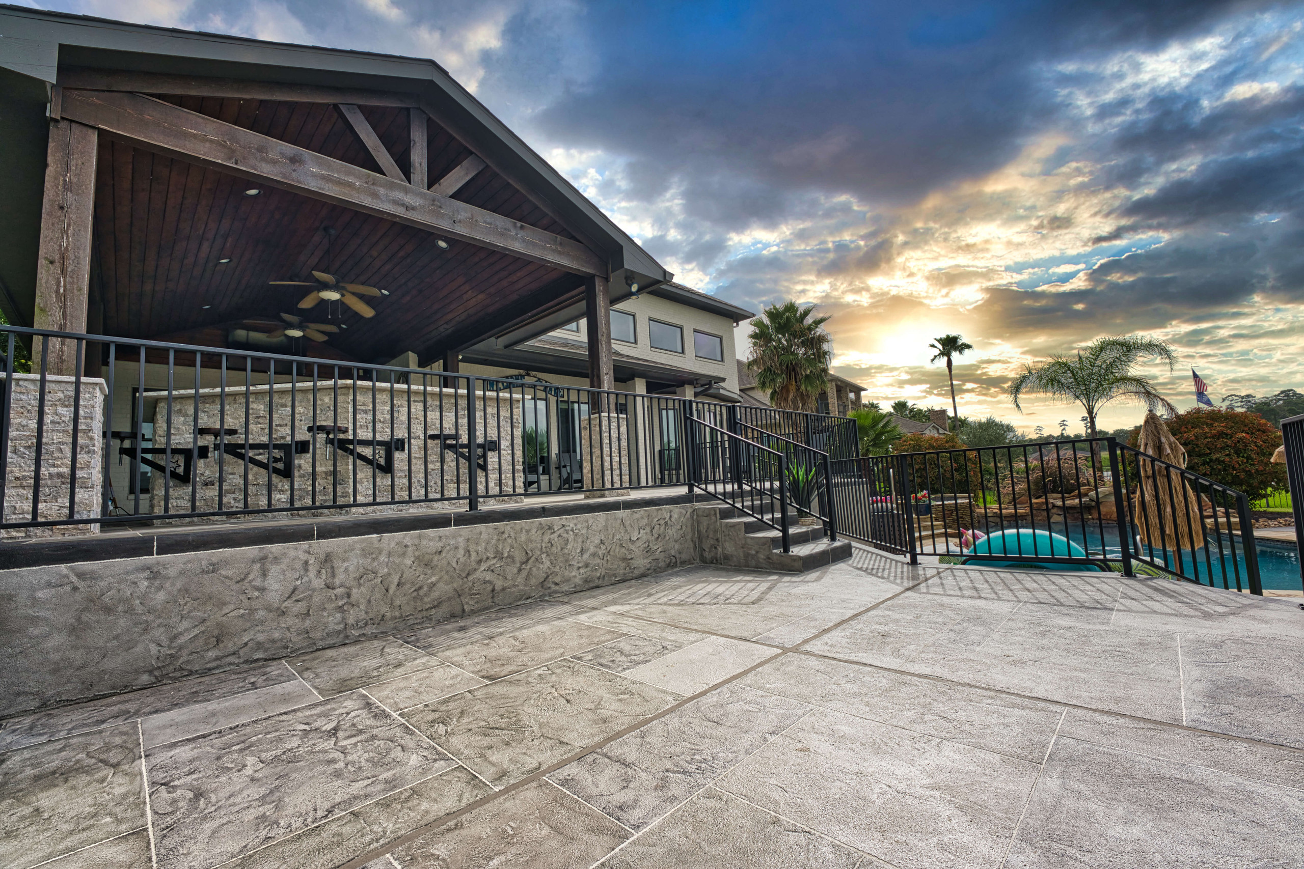 Covered patio and carvestone overlay patio backyard design oasis