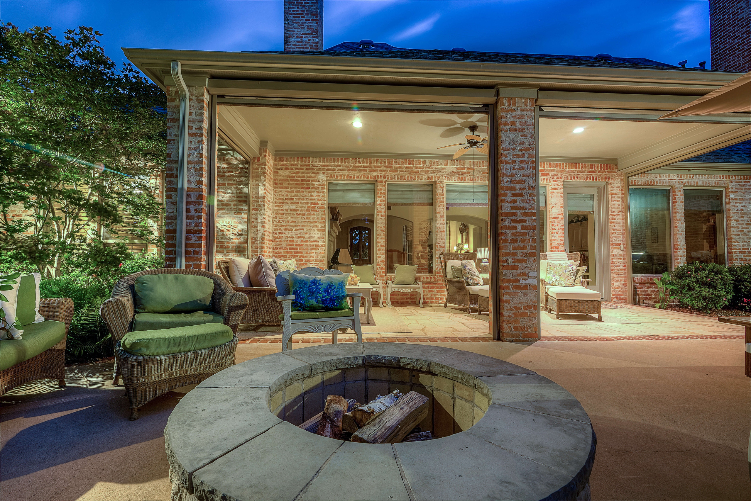 Custom built stone firepit and patio cover with seating area