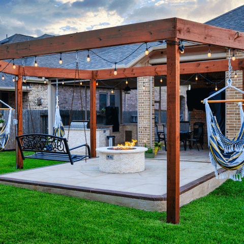 Custom built swing structure and stone detailed fire pit