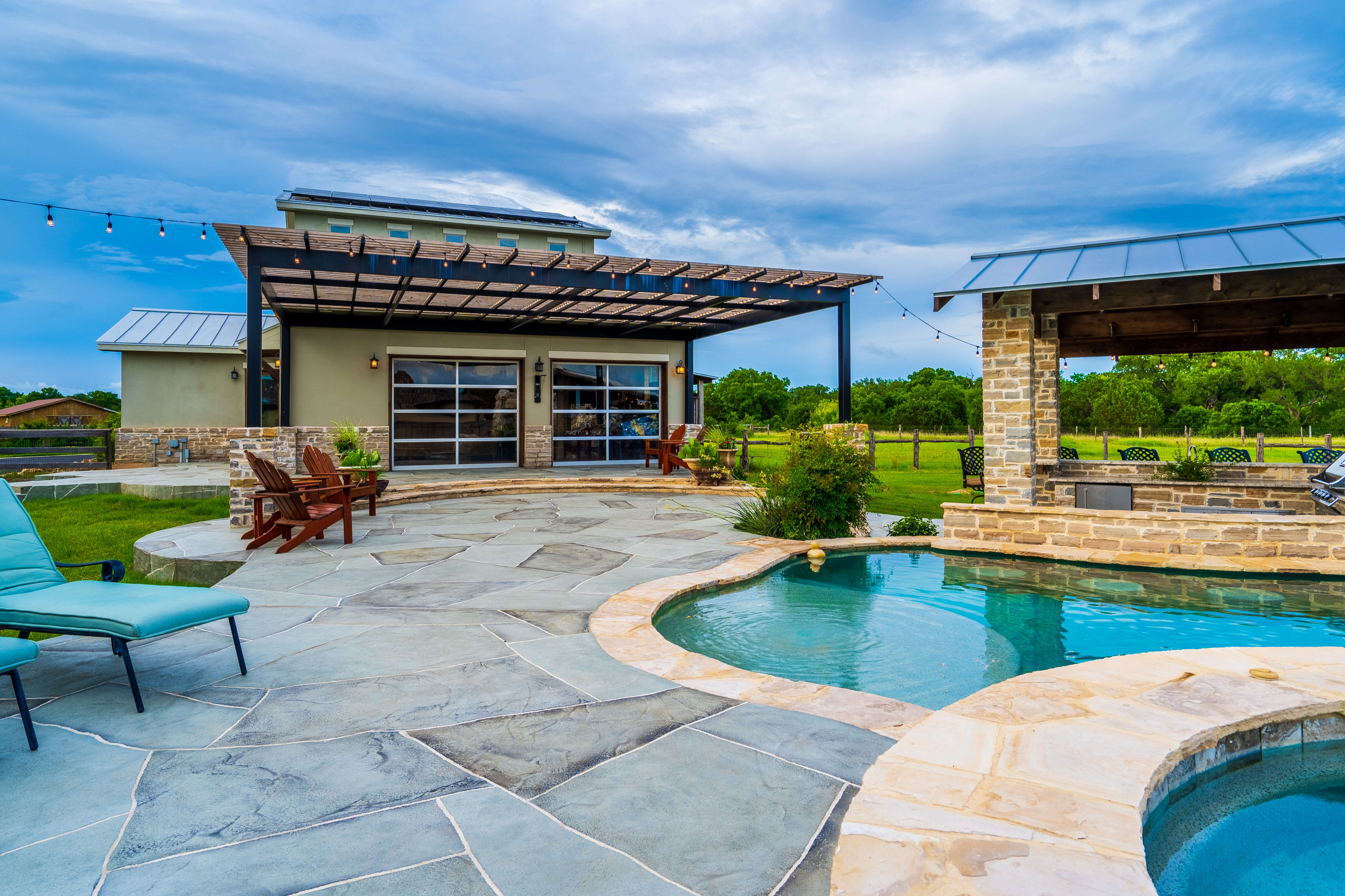 Carvestone pool deck and shaded pergola