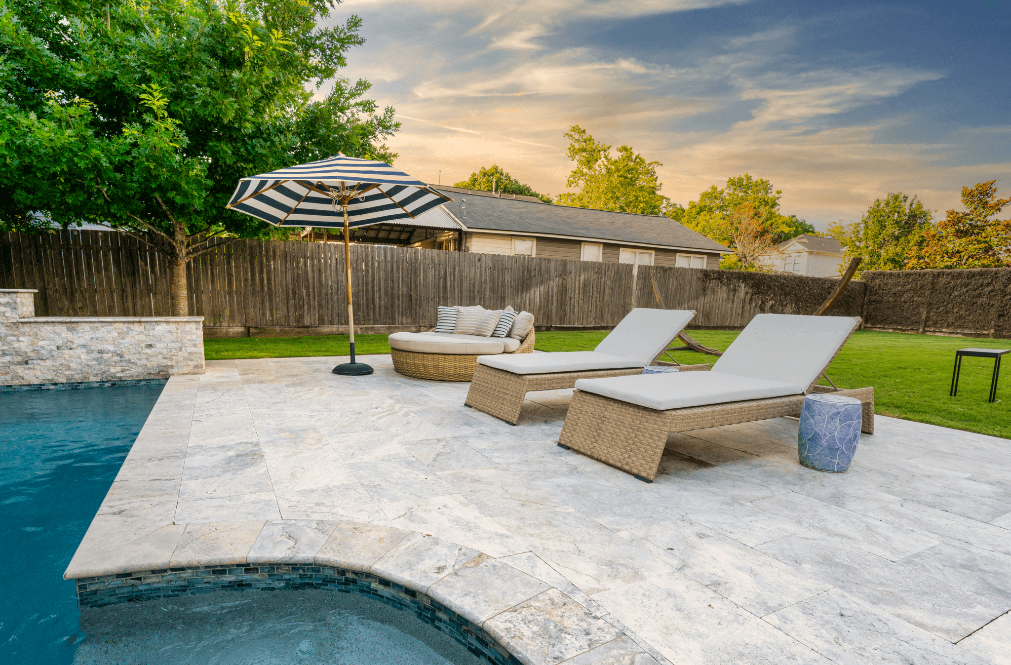 Modern travertine pool decking and poolside furniture