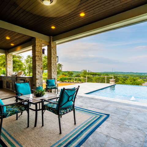 Outdoor living room with kitchen and pool view