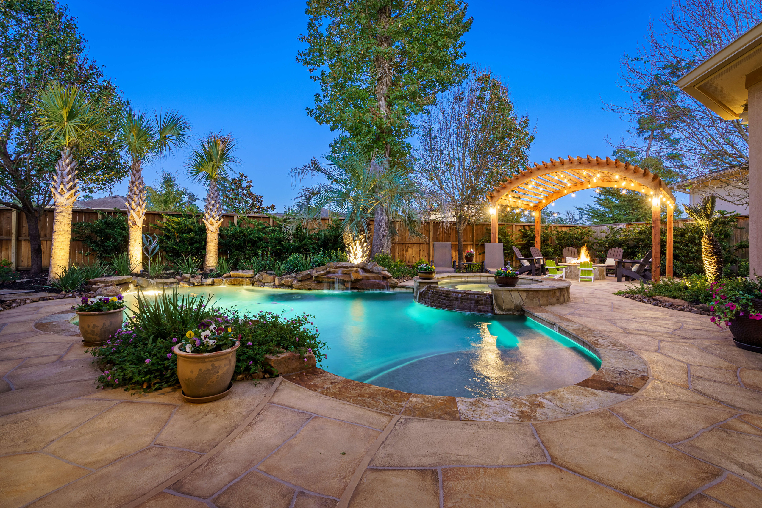 Backyard pool decking and pergola with outdoor string lights