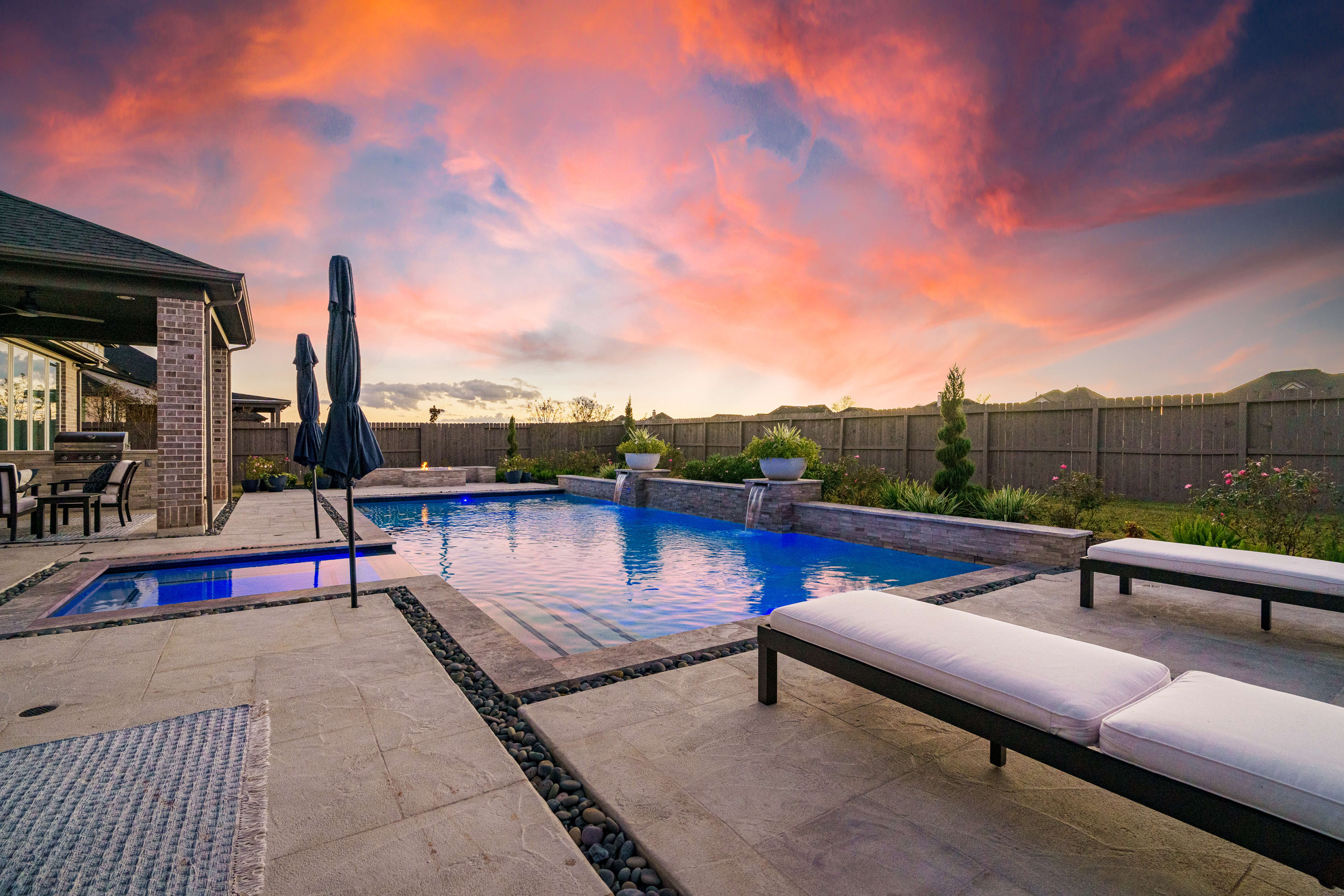 Rectangular inground pool shape with stone detailing and water fountain features