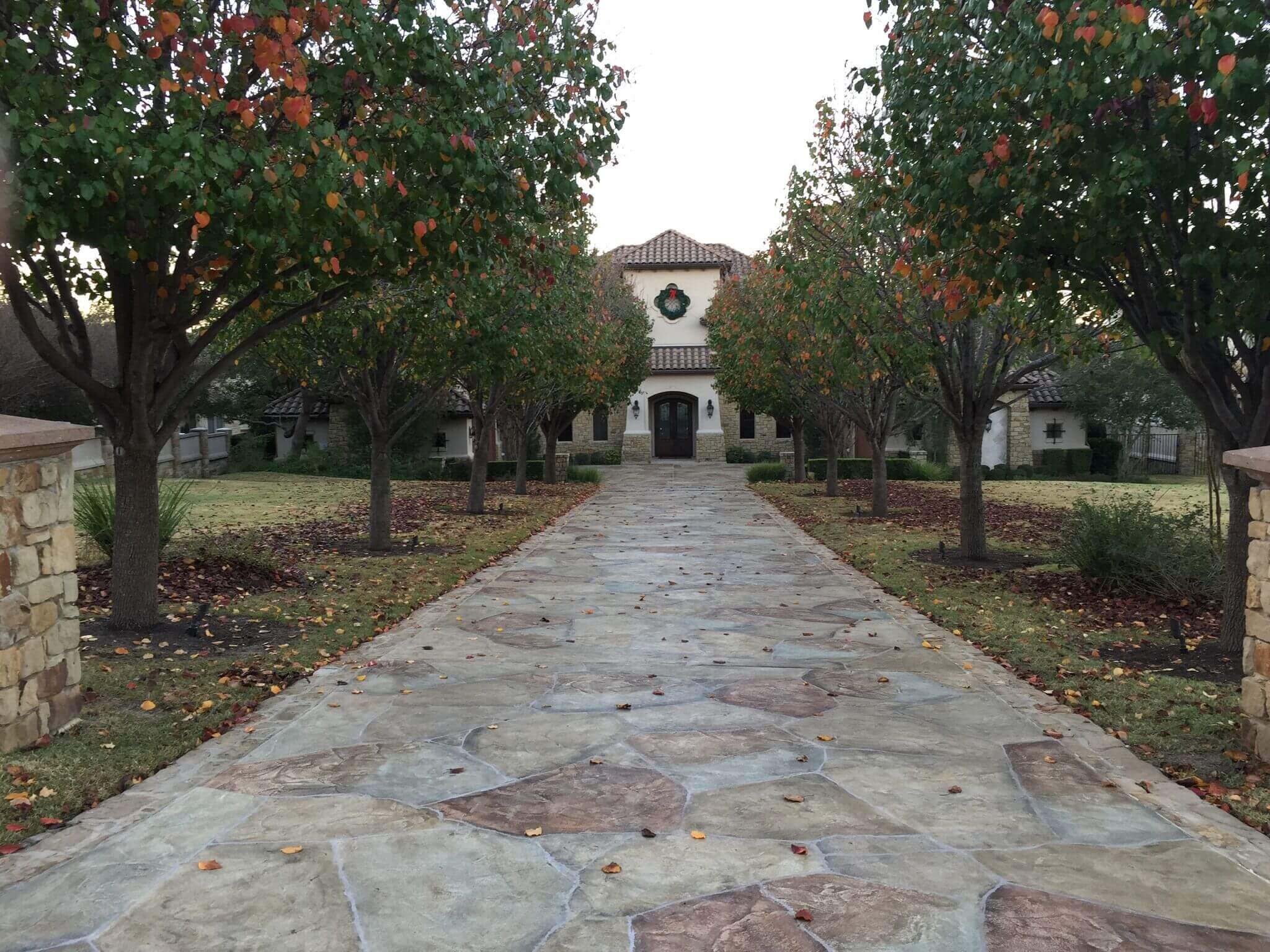 Update concrete driveway with beautiful carvestone overlay design Texas hardscape product