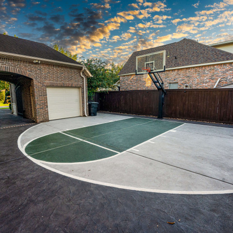 Custom carvestone concrete overlay hand-carved basketball court driveway in Houston Texas