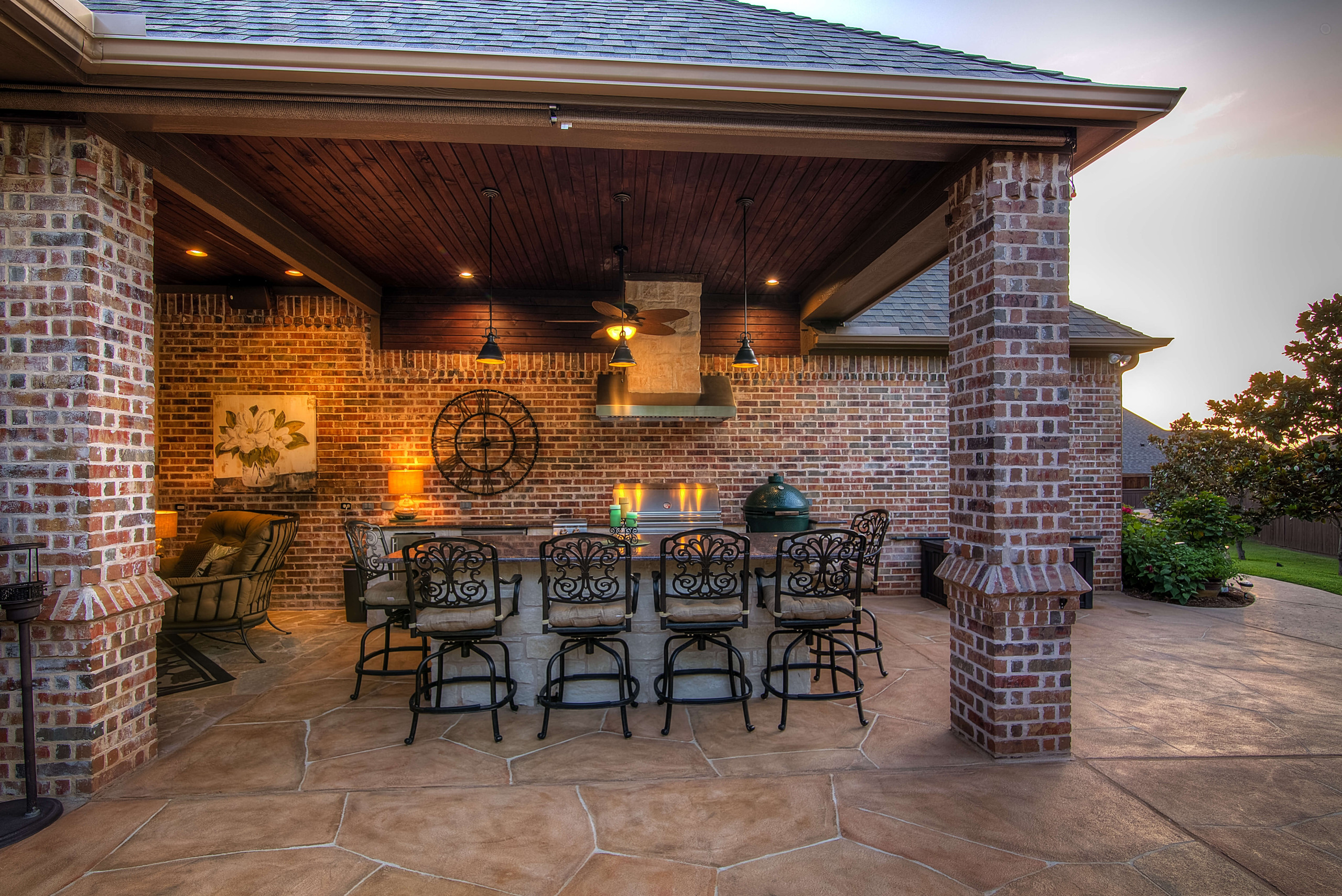 Backyard carvestone concrete overlay patio and outdoor kitchen in Texas