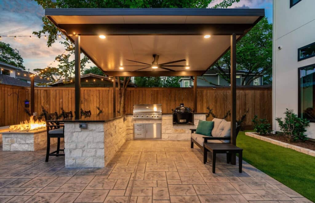 Outdoor kitchen with covered bar, grill, and seating
