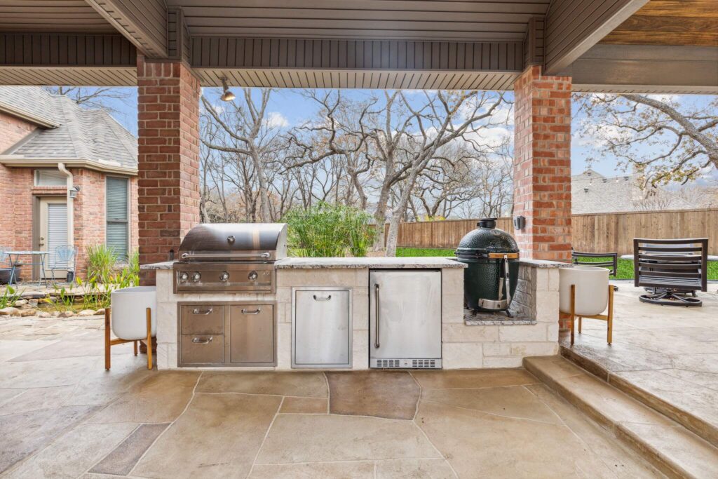 Outdoor kitchen with built-in grill and covered patio
