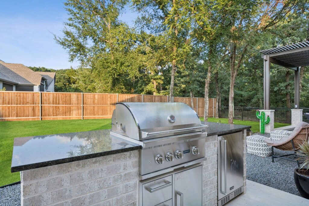 Outdoor kitchen with built-in grill and stone counter