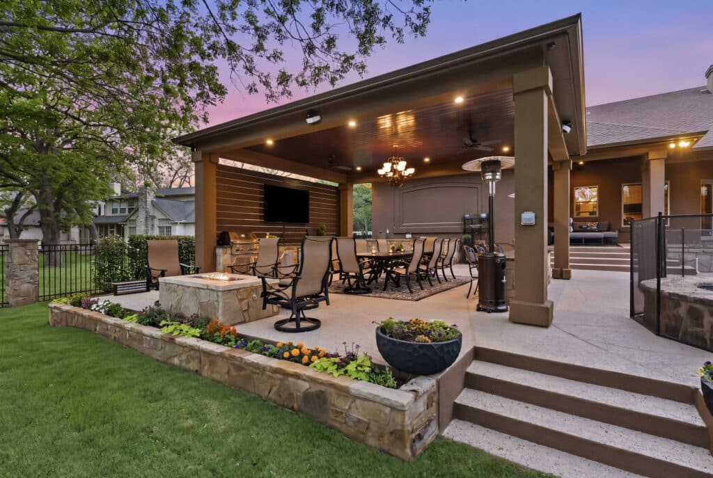 Shade structure over an outdoor dining patio with lighting and seating