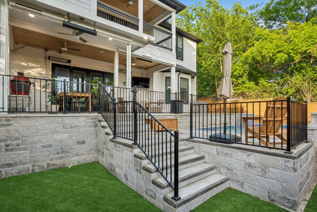 Backyard pool deck with stairs and covered patio area