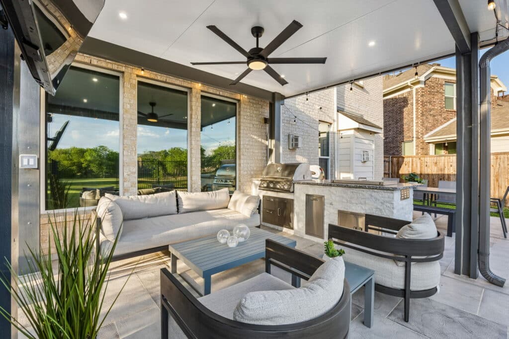 Outdoor kitchen patio concrete design with covered seating and grill area