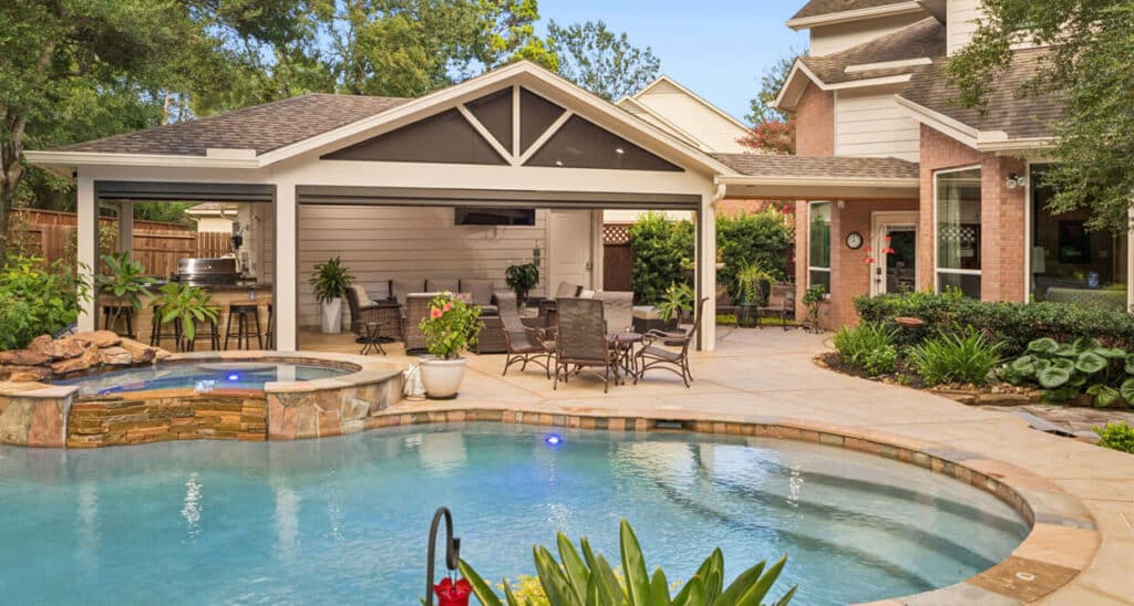 After view of pool patio with covered outdoor kitchen