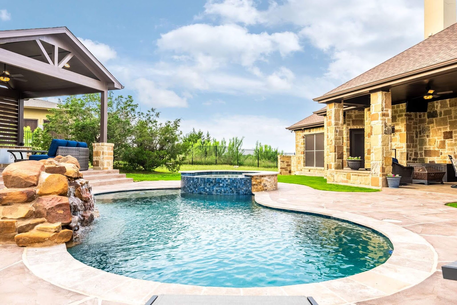 inground pool and hot tub remodel with custom rock waterfall