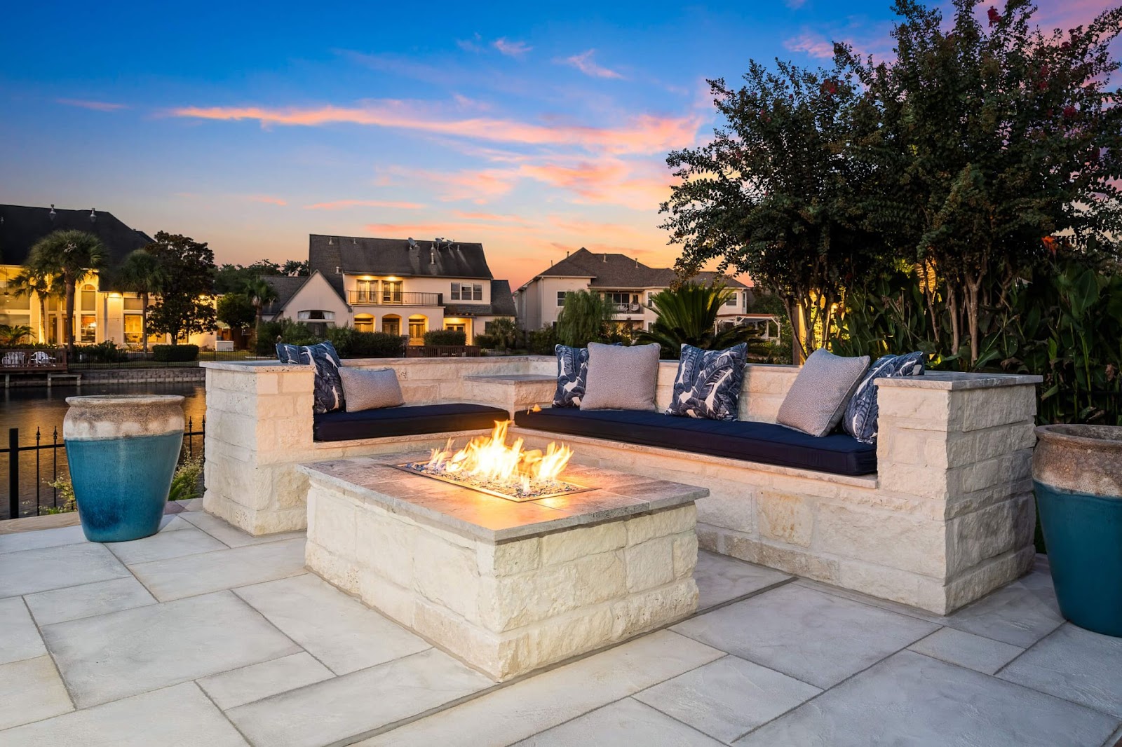 custom modern outdoor patio with custom fire table, white and blue design with carvestone flooring