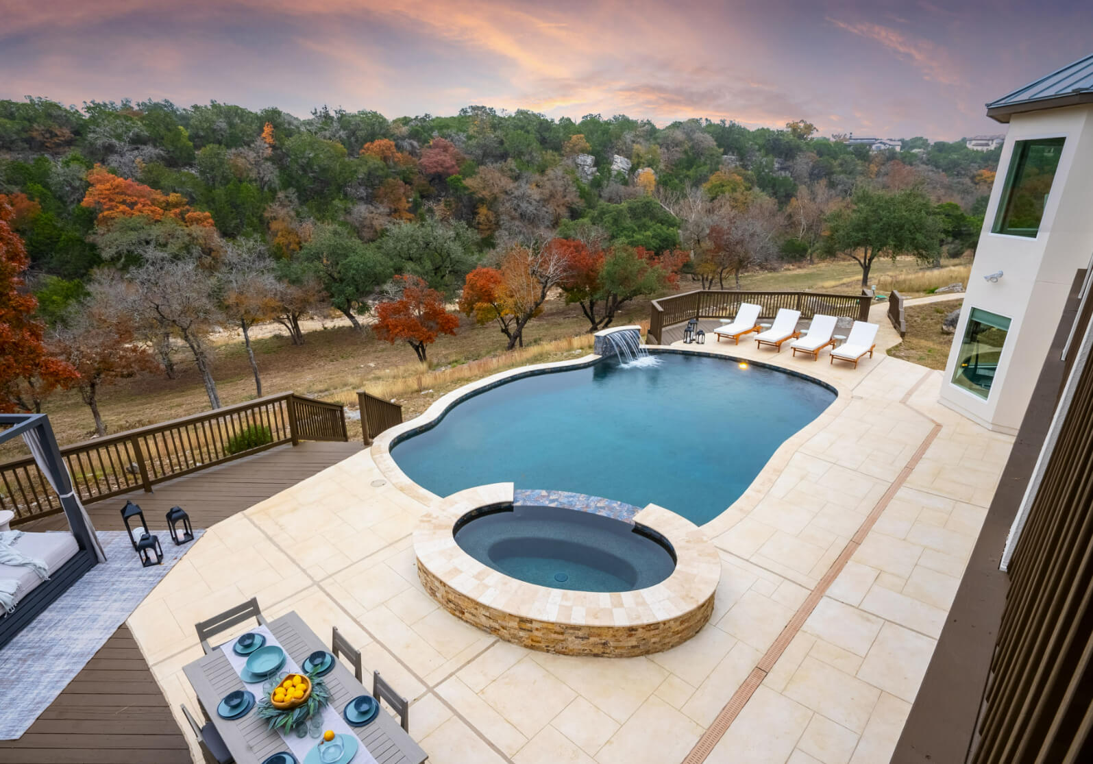 tranquil hillside backyard design with inground pool, hot tub, outdoor dining area