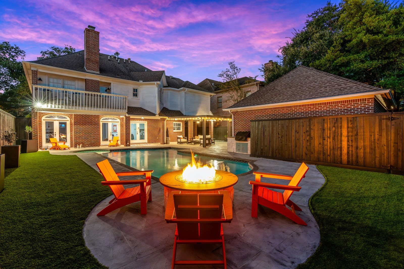 austin texas outdoor living backyard design idea with custom fire pit, pool and patio cover